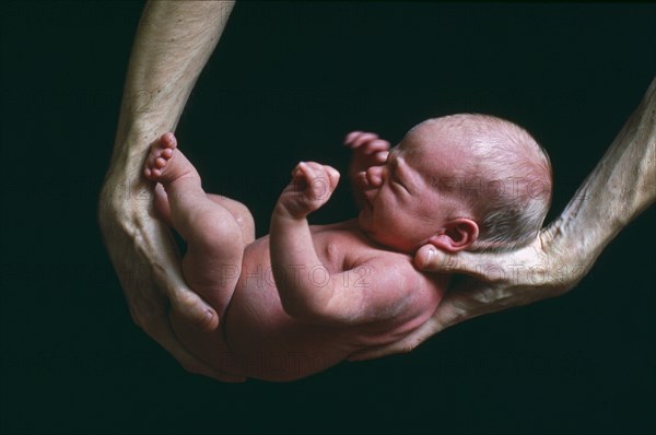 Father Holding Newborn Baby