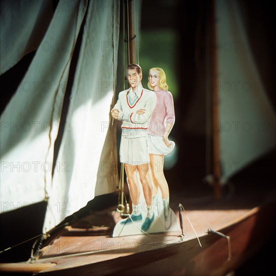 Male and Female Paper Doll on Boat