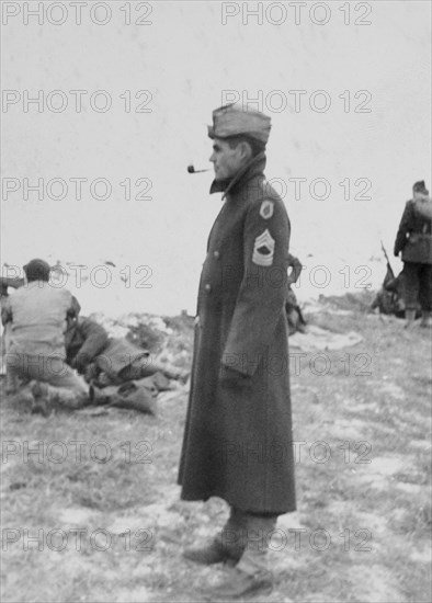 Military Soldier in Long Coat Smoking Pipe, Portrait, WWII, HQ 2nd Battalion, 389th Infantry, US Army Military Base, Indiana, USA, 1942