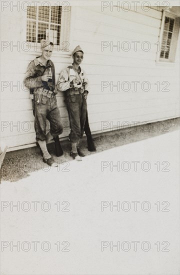 Portrait of Military Soldiers Leaning Against Military Building, WWII, 2nd Battalion, 389th Infantry, US Army Military Base, Indiana, USA, 1942