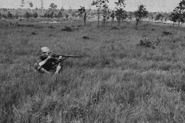 Sitting Soldier Displaying Proper Shooting Position in Field During Training Session, WWII, 2nd Battalion, 389th Infantry, US Army Military Base Indiana, USA, 1942