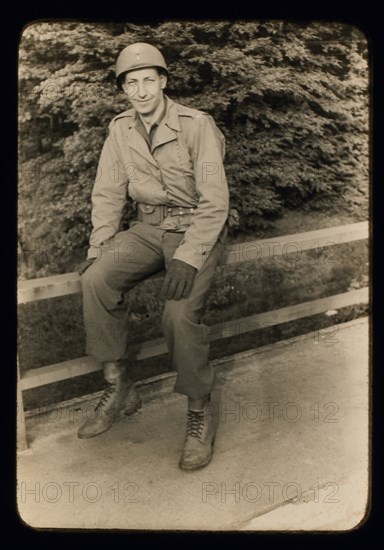 Smiling Soldier Sitting on Railing, Portrait, WWII, Third Army Division, US Army military, Europe, 1943