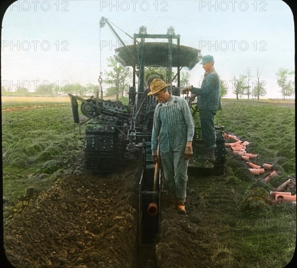 Farmers Digging Ditch with Tractor and Laying Drain Tile, Wisconsin, USA, Magic Lantern Slide, circa 1915