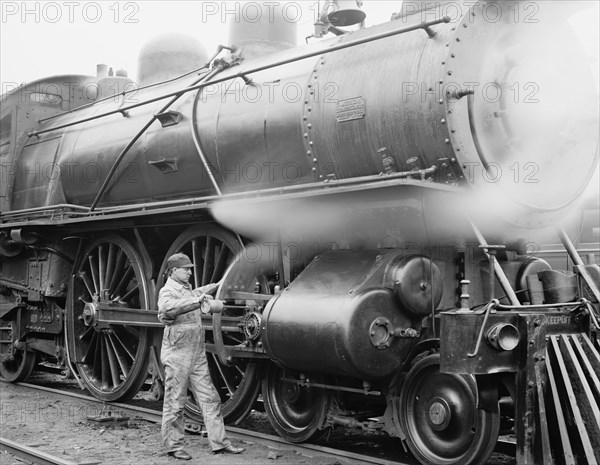 Mechanic Oiling Gears on Train, USA, Detroit Publishing Company, 1904