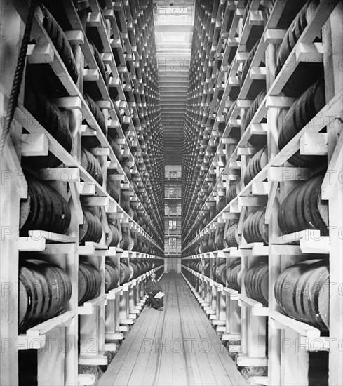 Worker Sitting in Rack Warehouse, Hiram Walker & Sons, Walkerville, Ontario, Canada, Detroit Publishing Company, 1910