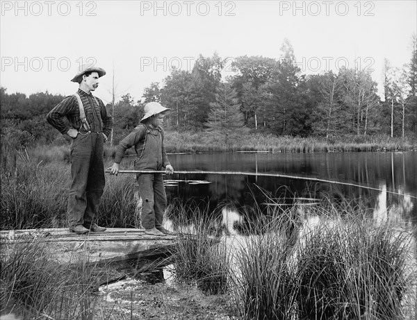 Man and Boy Fishing in Lake, USA, Detroit Publishing Company, 1915