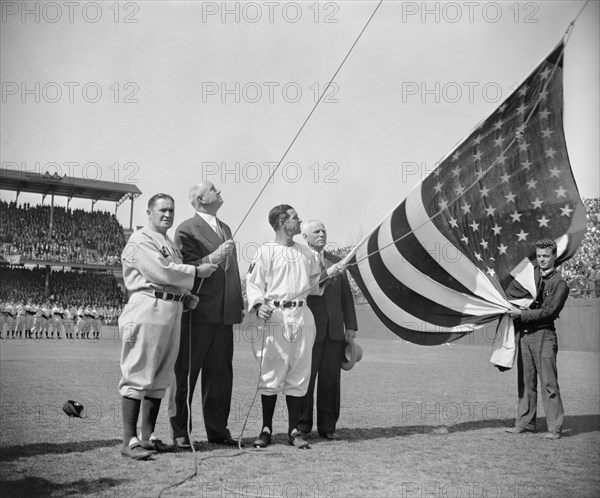 New York Yankee Manager Joe McCarthy, Postmaster General James A. Farley, Washington Senator's Manager Bucky Harris, and Clark Griffith, owner of Senators, Raising Flag before First Baseball Game of Season, Washington DC, USA, Harris & Ewing, April 21, 1939