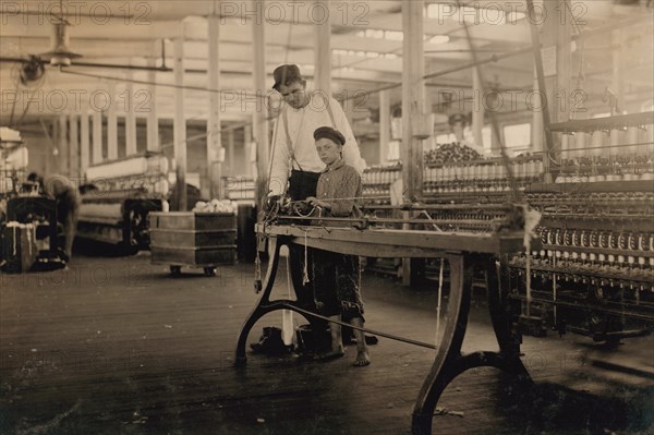 Young "Band-Boy" and Overseer, Yarn Mill, Yazoo City, Mississippi, USA, Lewis Hine, 1911