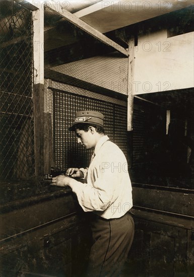 Postal Telegraph Boy Learning to Send Messages during Spare Moment, New York City, New York, USA, Lewis Hine, 1910