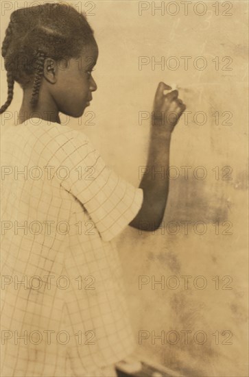 Young Girl Writing on Chalkboard in Classroom, Pleasant Green School, Marlinton, Pocahontas County, West Virginia, USA Lewis Hine, 1921