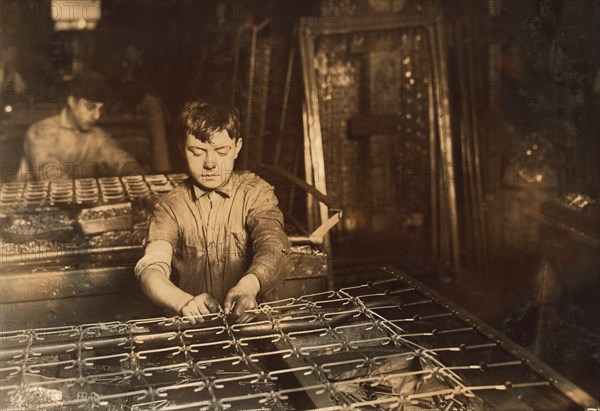Young Boy Linking Bed Springs, Boston, Massachusetts, USA, Lewis Hine, 1917