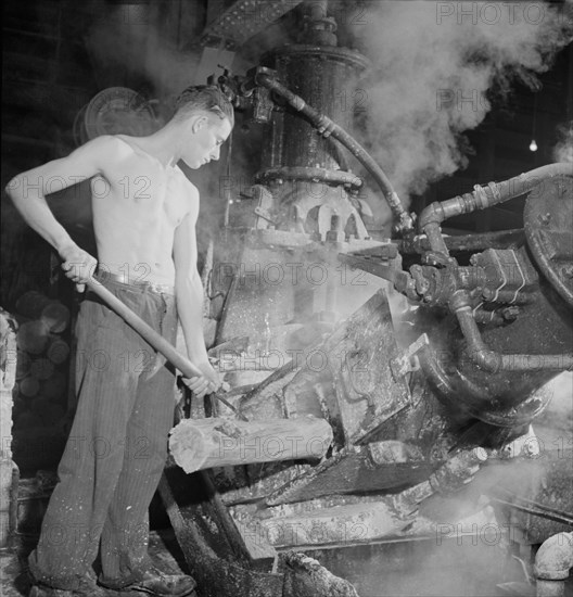 Worker at Machine that Grinds Wood into Pulp, Mississquoi Corporation Paper Mill, Sheldon Springs, Vermont, USA, Jack Delano for Farm Security Administration, September 1941