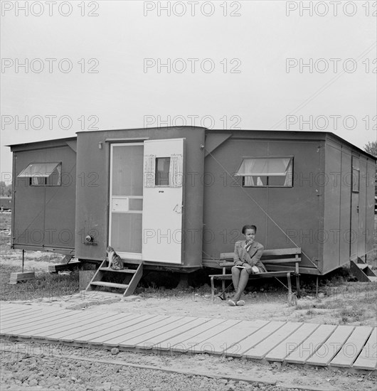 Young Woman Sitting Outside Farm Security Administration (FSA) Trailer Camp Project for African-Americans, Exterior of Expansible Trailer, Arlington, Virginia, USA, Marjorie Collins for Farm Security Administration, April 1942