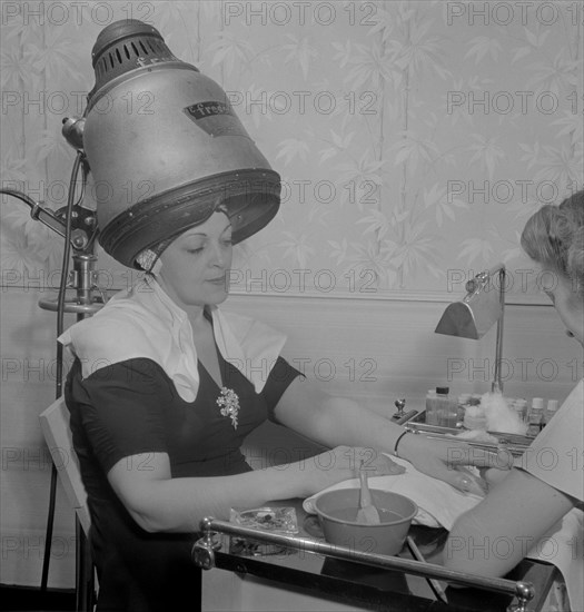 Woman Getting Manicure while Drying Hair at Hair Salon, Eighth Street, New York City, New York, USA, Marjorie Collins for Office of War Information, September 1942