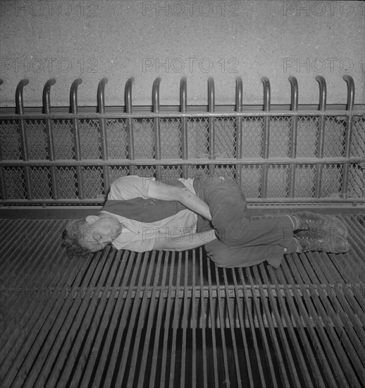 Bum Sleeping on Grate, the Bowery near 7th Street, New York City, New York, USA, Marjorie Collins for Office of War Information, September 1942