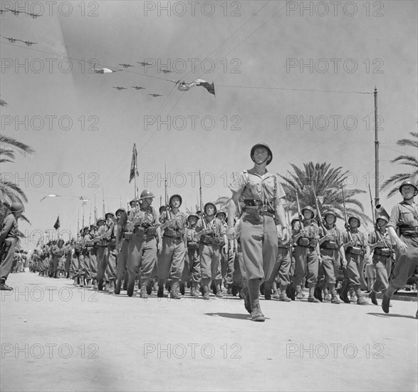 French Troops Passing Reviewing Stand in Allied Victory Parade along Avenue Gambetta as American Planes Fly Overhead in Show of Allied Might, Tunis, Tunisia, Marjorie Collins for Office of War Information, May 20, 1943