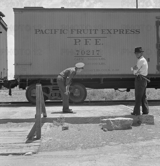 Men Inspecting Freight Train from Mexico for Smuggled Immigrants, El Paso, Texas, USA, Dorothea Lange for Farm Security Administration, June 1938