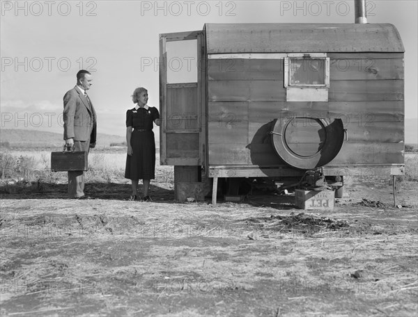 Doctor and Nurse Visiting Sick Child in Mobile Home at Farm Security Administration (FSA) Mobile Camp, Merrill, Klamath, County, Oregon, USA, Dorothea Lange for Farm Security Administration, October 1939