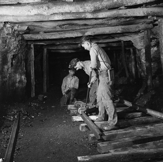 Three Miners Laying Track in Montour No. 4 Mine of Pittsburgh Coal Company, Pittsburgh, Pennsylvania, USA, John Collier for Office of War Information, November 1942