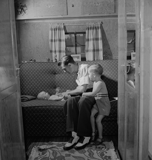 Father with Two Children in Trailer Home at Glenn L. Martin Trailer Village, a Farm Security Administration (FSA) Housing Project, Middle River, Maryland, USA, John Collier for Office of War Information, August 1943