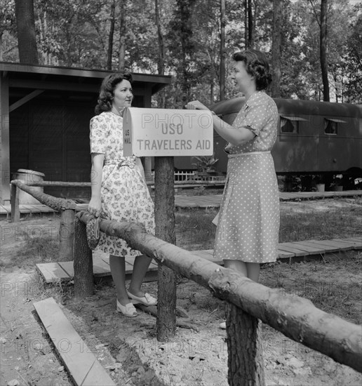 United Service Organization (USO) Traveler's Aide Giving Information to Newcomer in Glenn L. Martin Trailer Village, a Farm Security Administration (FSA) Housing Project, Middle River, Maryland, USA, John Collier for Office of War Information, August 1943