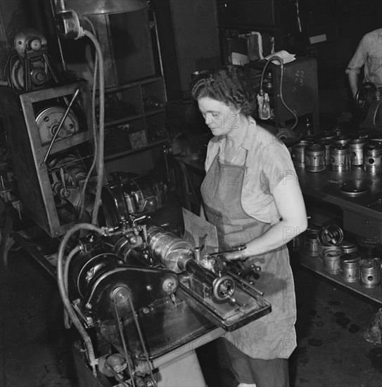 Female Mechanic Working on Cylinder Grinding Machine at Greyhound Bus Garage, Pittsburgh, Pennsylvania, USA, Esther Bubley for Office of War Information, September 1943