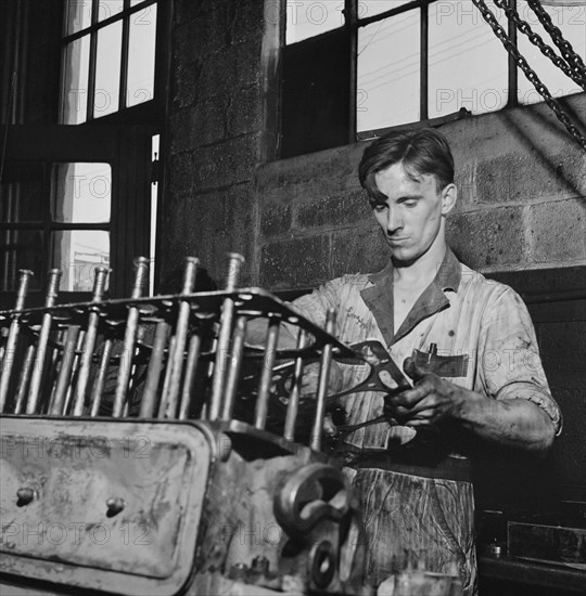 Mechanic Working on Greyhound Bus Engine at Garage, Pittsburg, Pennsylvania, USA, Esther Bubley for Office of War Information, September 1943