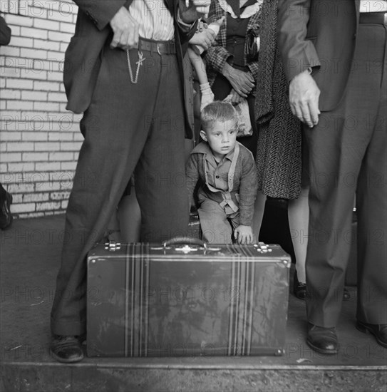 Young Boy with Group of People Waiting for Greyhound Bus during Trip from Louisville, Kentucky to Memphis, Tennessee, USA, Esther Bubley for Office of War Information, September 1943