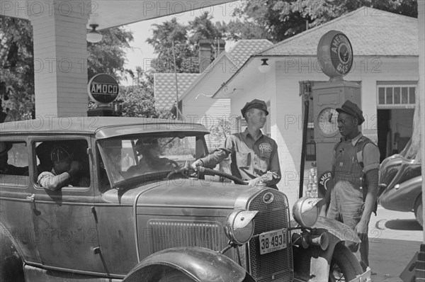 Gas Station Attendant Filling Car with Gasoline, Atlanta, Georgia, USA, Marion Post Wolcott for Farm Security Administration, June 1939