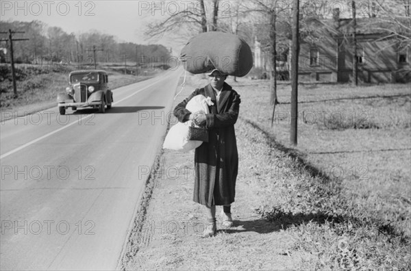 Woman Carrying Laundry Home Along Highway, Near Durham, North Carolina, USA, Marion Post Wolcott for Farm Security Administration, November 1939