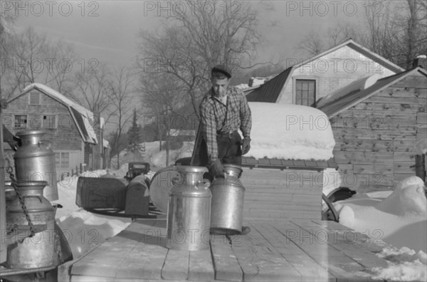 Farmer Bringing Cans of Milk to Crossroads Early in Morning where they are Picked up by Coop Farmers Truck and Delivered to City, near Woodstock, Vermont, USA, Marion Post Wolcott for Farm Security Administration, March 1940