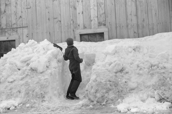 Young Boy Shoveling Snow from Barn Window after Heavy Snowfall, near Woodstock, Vermont, USA, Marion Post Wolcott for Farm Security Administration, April 1940