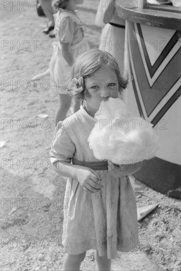 Young Girl Eating Cotton Candy, Cotton Carnival, Memphis, Tennessee, USA, Marion Post Wolcott for Farm Security Administration, May 1940