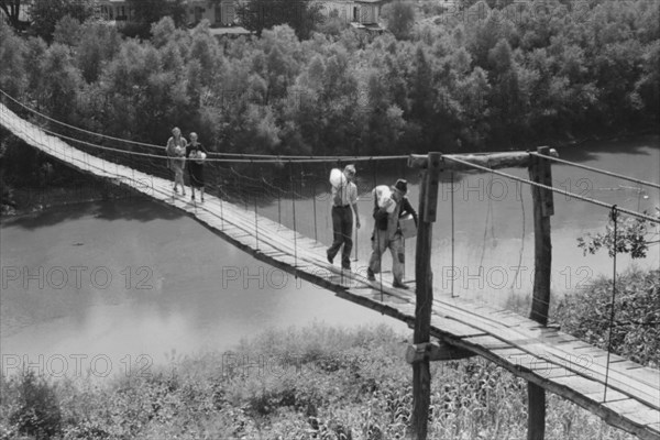 Family Carrying Home Groceries and Supplies Across Swinging Footbridge over River, near Jackson, Kentucky, Marion Post Wolcott for Farm Security Administration, August 1940