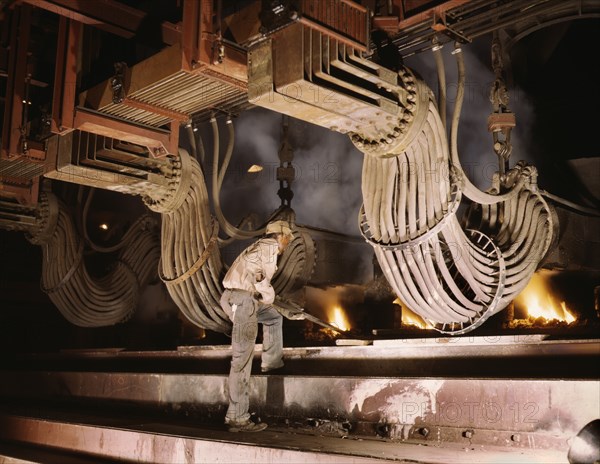 Worker at Large Electric Phosphate Smelting Furnace used in Making of Elemental Phosphorus in TVA Chemical Plant, near Muscle Shoals, Alabama, USA, Alfred T. Palmer for Office of War Information, June 1942