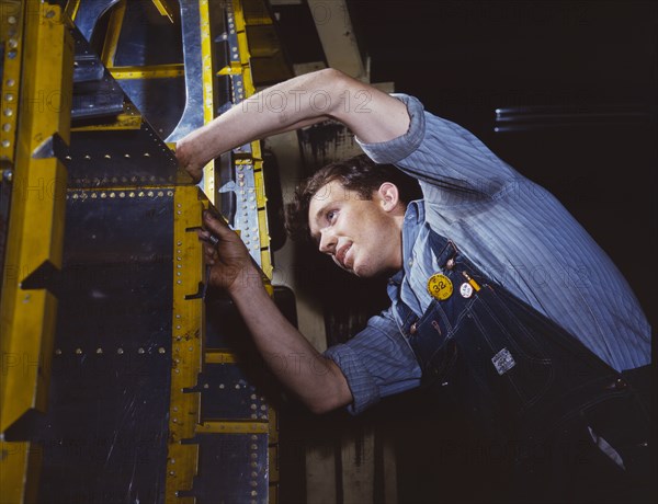 Man Assembling Wing Brace for B-25 Bomber on Assembly Line at Aircraft Plant, California, USA, Afred T. Palmer for Office of War information, 1942