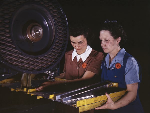 Two Female Workers Punching Holes in Frame Member for B-25 Bomber, North American Aviation, Inc, Inglewood, California, USA, Alfred T. Palmer for Office of War Information, June 1942
