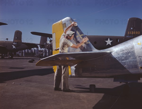 Painter Cleaning Tail Section of P-51 Fighter Plane on Outdoor Assembly Line Prior to Spraying Olive-Drab Camouflage of U.S. Army, North American Aviation, Inc, Inglewood, California, USA, Alfred T. Palmer for Office of War Information, October 1942
