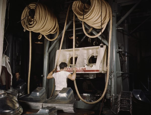 Factory Worker Assisting Huge Drop Hammer with Hemp Rope to Manufacture Sheet Metal Parts for United Nations Bombers and Fighter Planes, North American Aviation, Inc, Inglewood, California, USA, Alfred T. Palmer for Office of War Information, October 1942