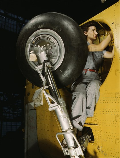 Female Worker Making Final Adjustments in Wheel Well of Inner Wing Before Installation of Landing Gear, Vultee "Vengeance" Dive Bomber, Nashville, Tennessee, USA, Alfred T. Palmer for Office of War Information, February 1943