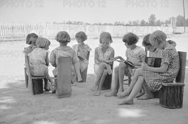 Young Girls Reading Books in Schoolyard, Cumberland Mountain Farms, near Scottsboro, Alabama, USA, Carl Mydans for U.S. Resettlement Administration, June 1936