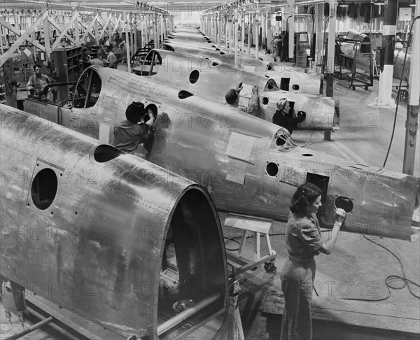 Workers on P-51 Fuselage Overhead Conveyor Line, North American Aviation Plant, Inglewood, California, USA, Alfred T. Palmer for Office of War Information, October 1942