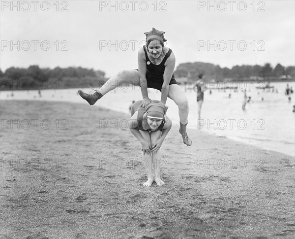 Two Young Women Playing Leap Frog on Beach, USA, National Photo Company, 1921
