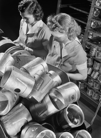 Two Female Workers Inspecting Heat-Treated Pistons prior to Brinnell hardness Testing at Aluminum Factory Converted to War Production, Aluminum Industries, Inc., Cincinnati, Ohio, USA, Alfred T. Palmer for Office of War Information, February 1942