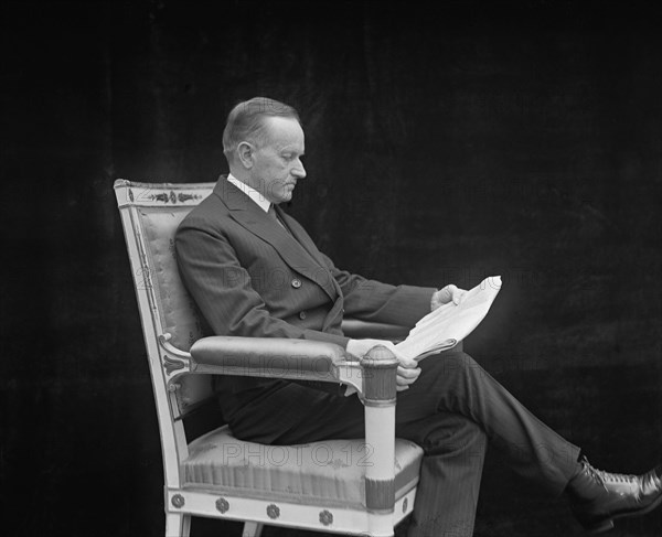 U.S. President Calvin Coolidge, Portrait Reading Newspaper, Washington DC, USA, National Photo Company, May 1924