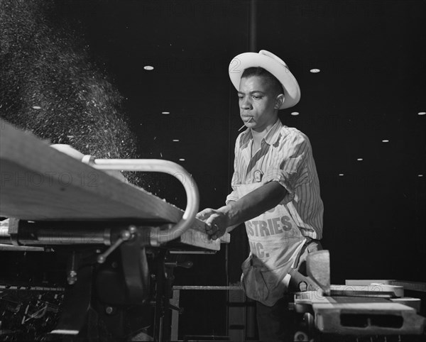 Carpenter Building Torpedo Boats at Shipyard during WWII, New Orleans, Louisiana, USA, Howard R. Hollem for Office of War Information, July 1942