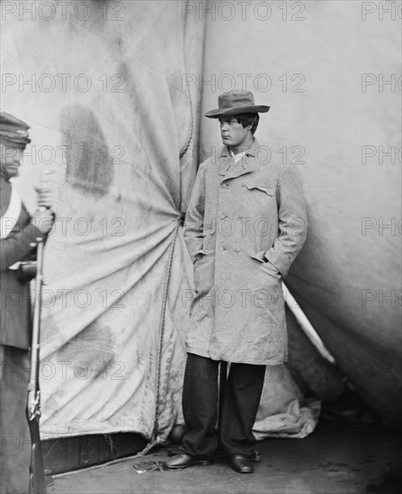 Lewis Powell, also known as Lewis Payne, Attacker of U.S. Secretary of State William H. Seward, and Conspirator in Assassination of U.S. President Abraham Lincoln, Standing in Overcoat with Hat, Washington Navy Yard, Washington DC, USA, by Alexander Gardner, April 1865