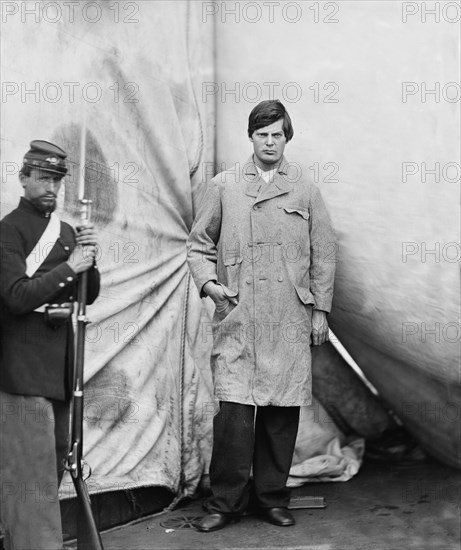 Lewis Powell, also known as Lewis Payne, Attacker of U.S. Secretary of State William H. Seward, and Conspirator in Assassination of U.S. President Abraham Lincoln, Standing in Overcoat, Washington Navy Yard, Washington DC, USA, by Alexander Gardner, April 1865