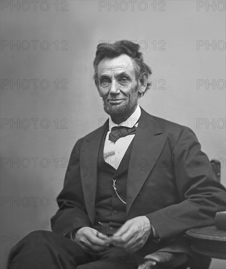 U.S. President Abraham Lincoln, Portrait, Seated next to Table Holding Spectacles and Pencil, Washington DC, USA, by Alexander Gardner, February 1865