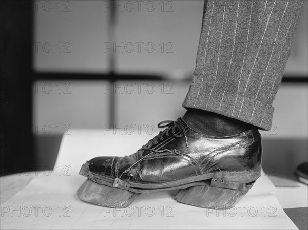 Policeman Trying on Cow Shoe used by Moonshiners during Prohibition, Washington DC, USA, National Photo Company, June 1924